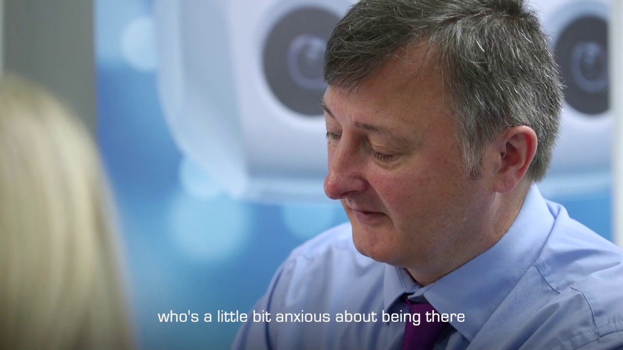 Audiologist engaging compassionately with a patient, helping ease anxiety during a consultation.