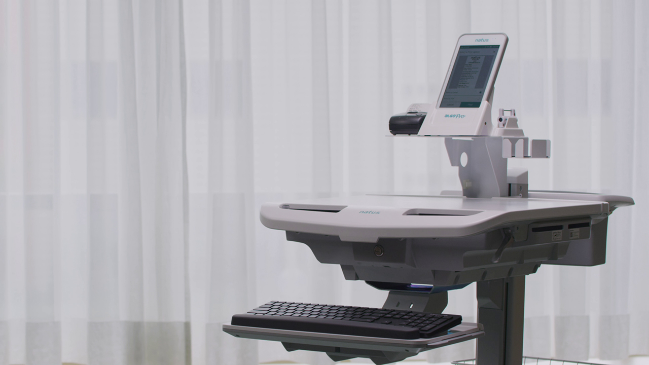 Side view of ALGO Pro Mobile Hearing Screening System with touchscreen and keyboard for infant hearing screening.