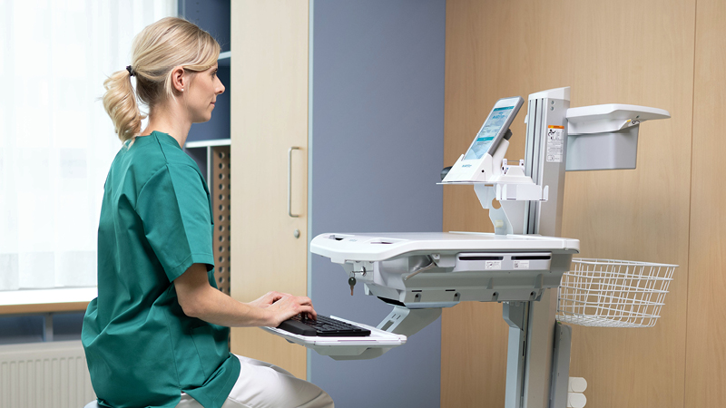 Healthcare professional using the ALGO Pro Mobile Hearing Screening System for newborn hearing assessments in a clinical setting.