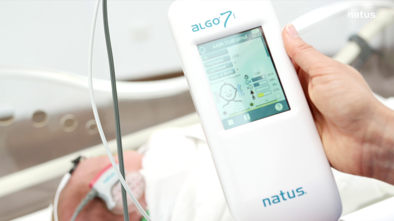 Clinician performing AABR test on a newborn using the ALGO 7i Infant Hearing Screening Device.