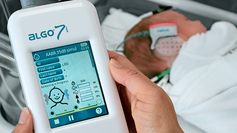 Clinician performing AABR test on a newborn using the ALGO 7i Newborn Hearing Screener.