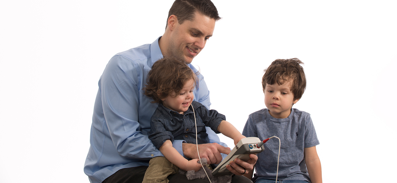 Clinician demonstrating the Bio-logic AuDX Portable OAE Screening Device during otoacoustic emissions screening.