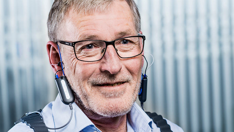 Man wearing Aurical FreeFit probes for real ear measurement in hearing aid fitting.