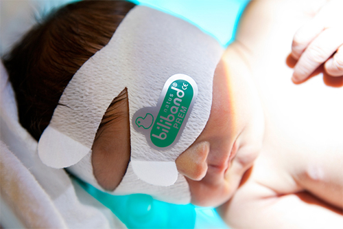 Newborn wearing Biliband Eye Protector during neonatal phototherapy treatment.