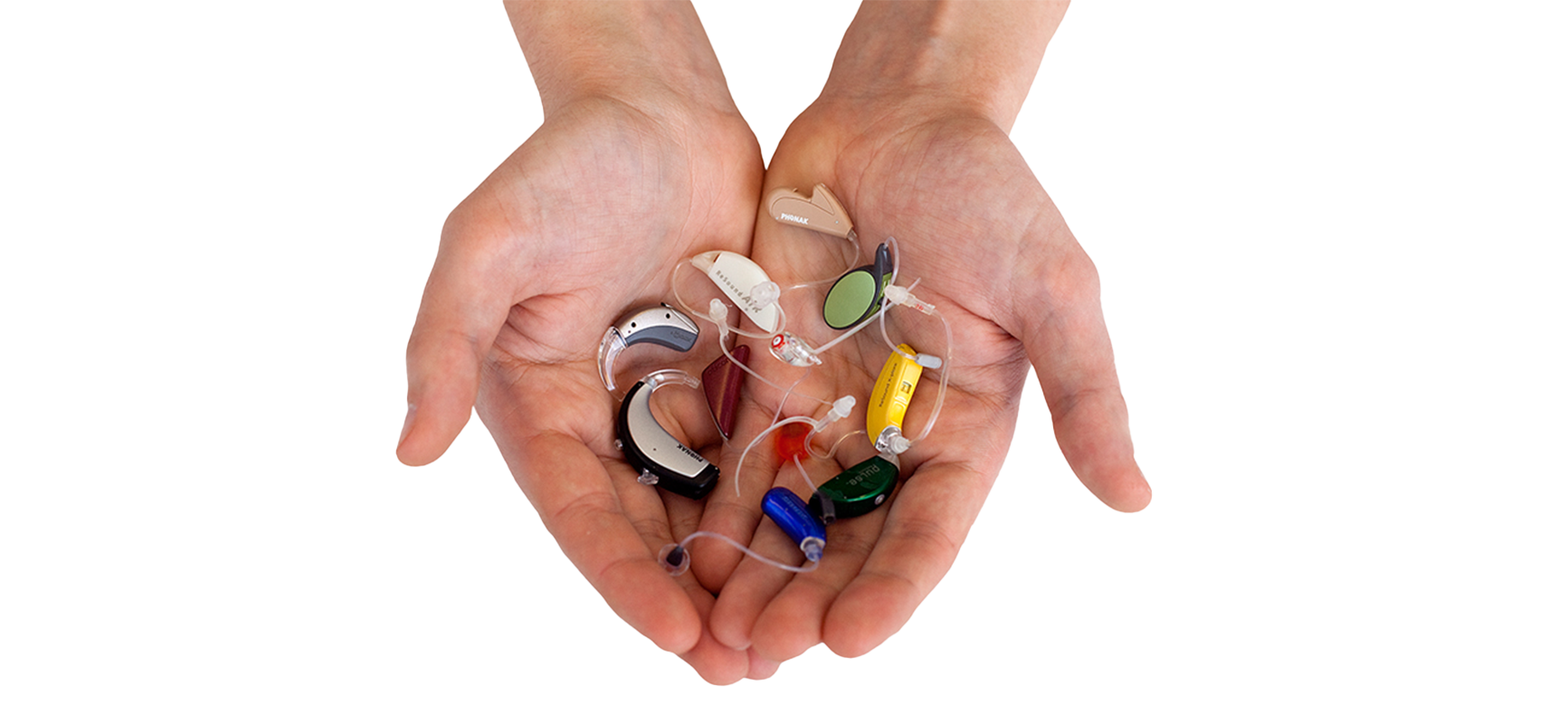 Hands holding various colorful hearing aids compatible with Hi-Pro 2 programming.