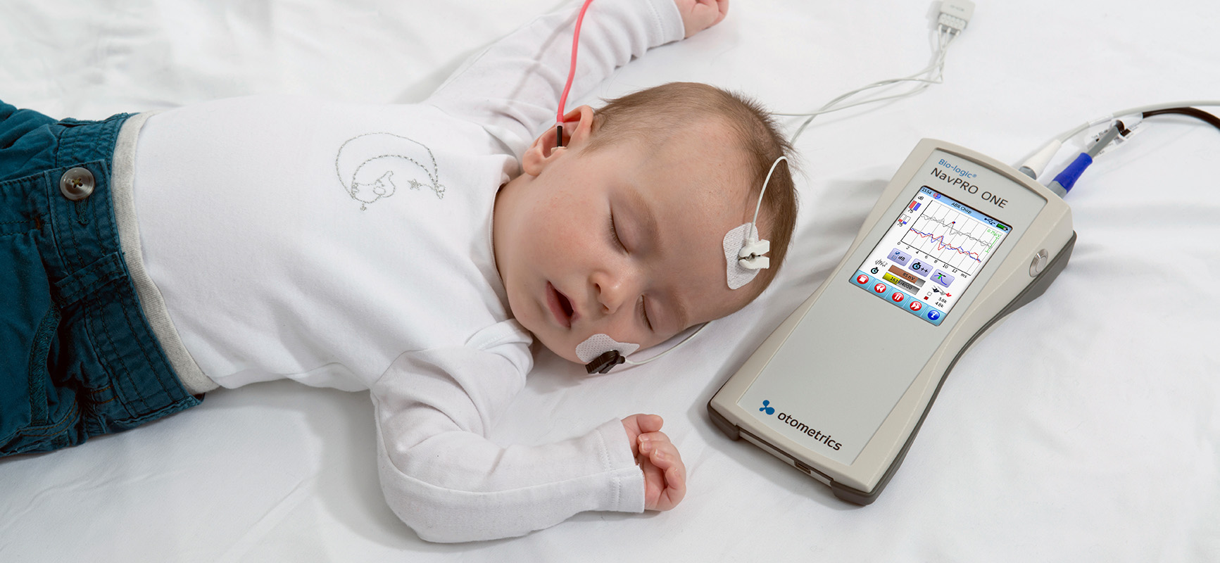Infant undergoing auditory brainstem response testing with Bio-logic NavPRO ONE diagnostic ABR device.