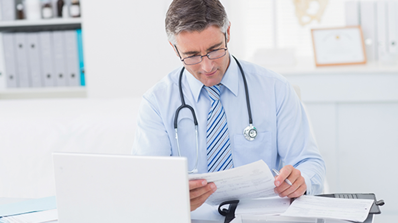 Healthcare provider reviewing newborn screening data using a patient management system.