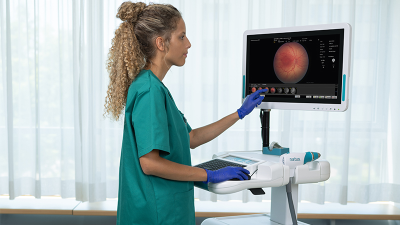 Clinician using RetCam Envision pediatric retinal imaging system to capture high-resolution ocular images.
