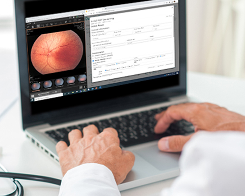Clinician using remote ophthalmic imaging for ROP diagnosis as part of telemedicine neonatal eye care.