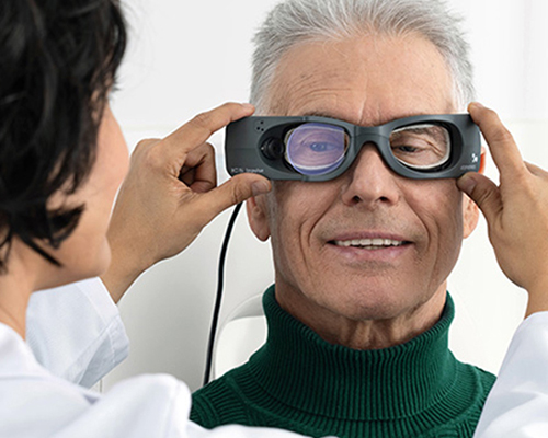 Clinician performing a vestibular function test on a patient using diagnostic goggles, illustrating best practices in audiology for assessing vestibular disorders and dizziness-related symptoms.